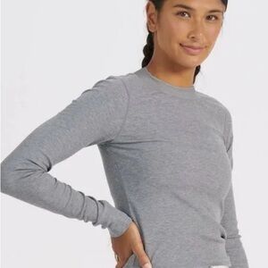 Vuori woman’s gray mock neck, long sleeve, top.